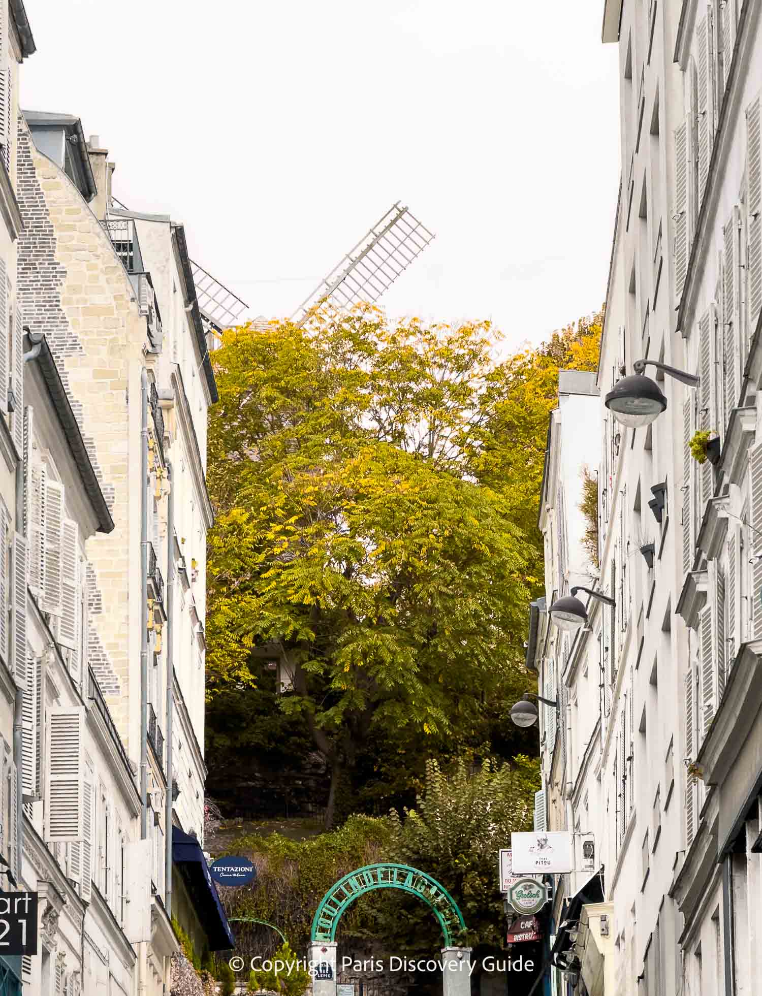 Fall foliage in Montmartre around Le Moulin Blute-Fin, a historical windmill