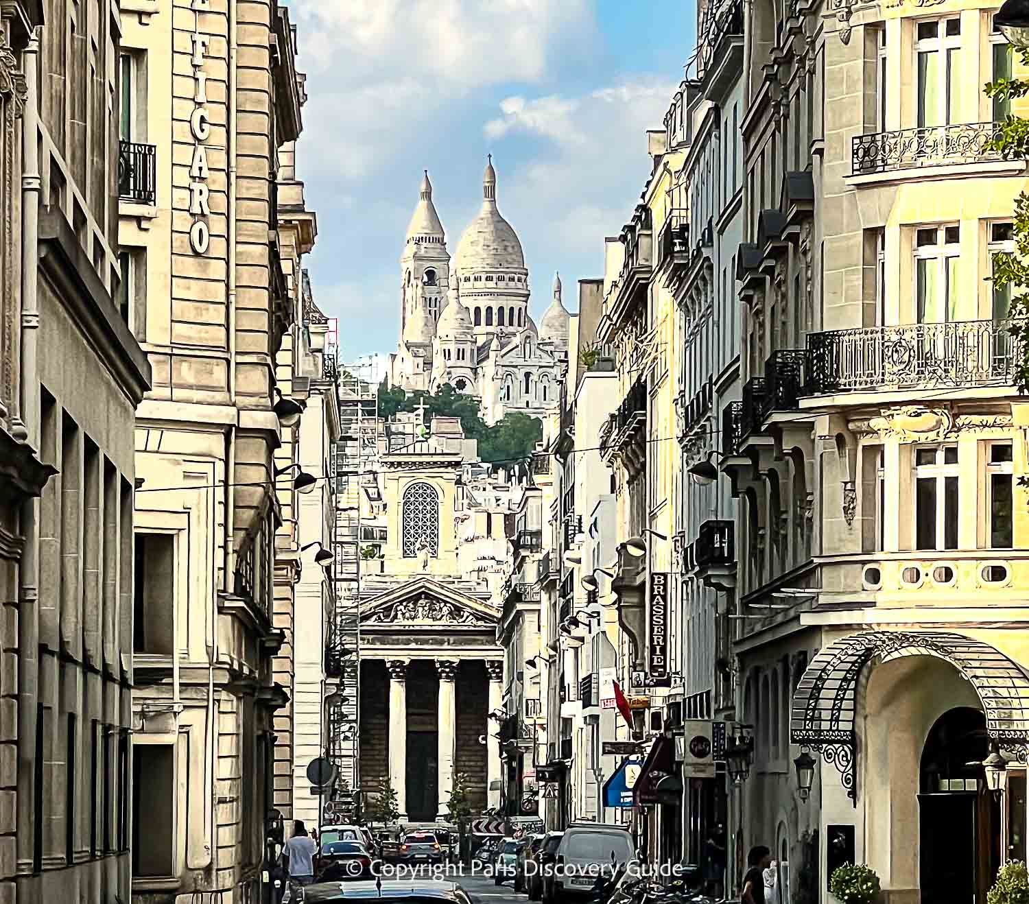 Looking up Rue Laffitte at SoPi's Eglise Notre Dame de Lorette and at the top of the hill, Sacre Coeur Basilica