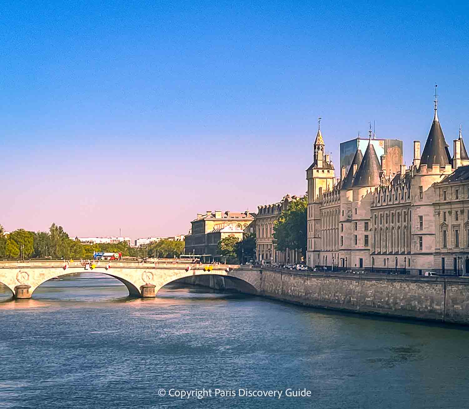 Giant statue perched on the edge of the Summer Terrace overlooking the Seine River, Pont Royal, and the Louvre