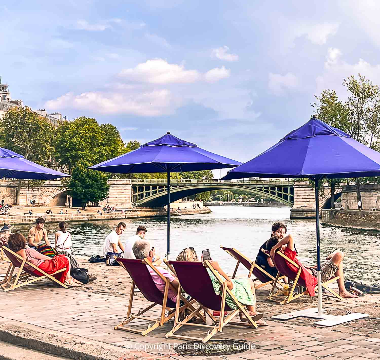People relaxing along the Seine River Banks People relaxing along the Seine River Banks