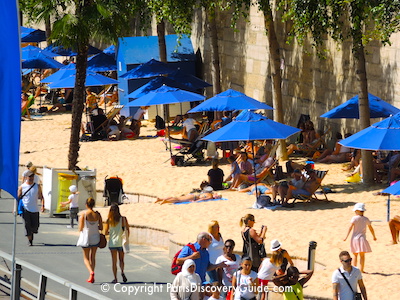 Paris Plage - sand and beach umbrellas along the Seine River Paris Plage - sand and beach umbrellas along the Seine River