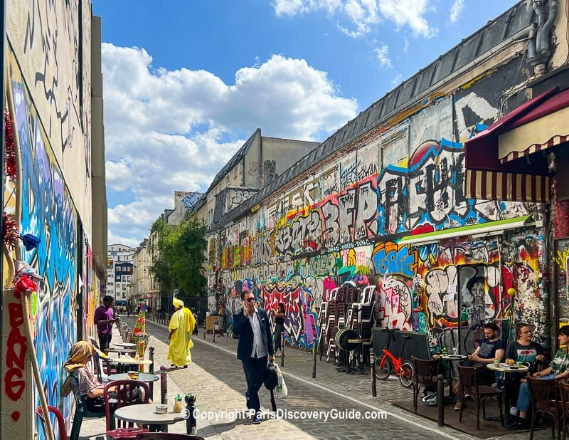 Street art and outdoor dining in the Belleville neighborhood near Babel Belleville Hotel