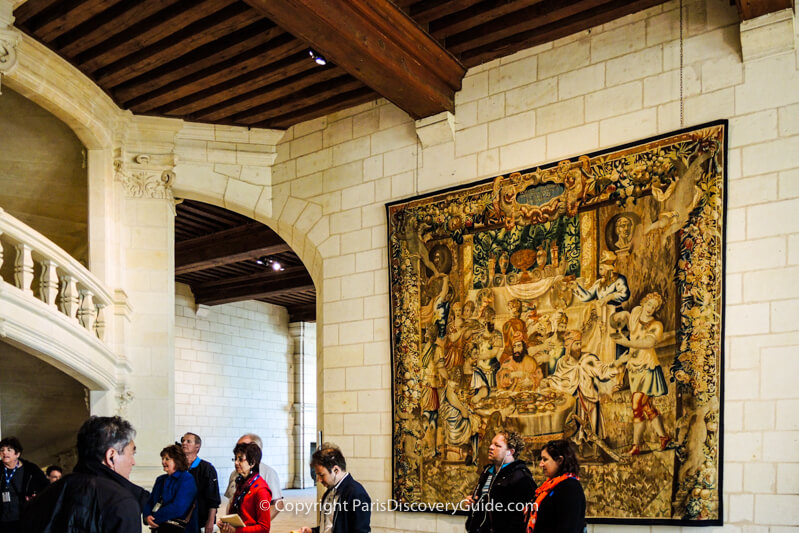 Tapestry, staircase, and beams inside Chambord Castle