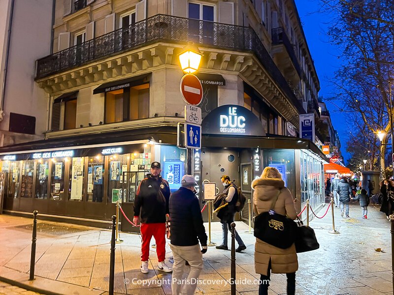 Rue des Lombards jazz club in Paris 1 near Les Halles on a cloudless winter evening