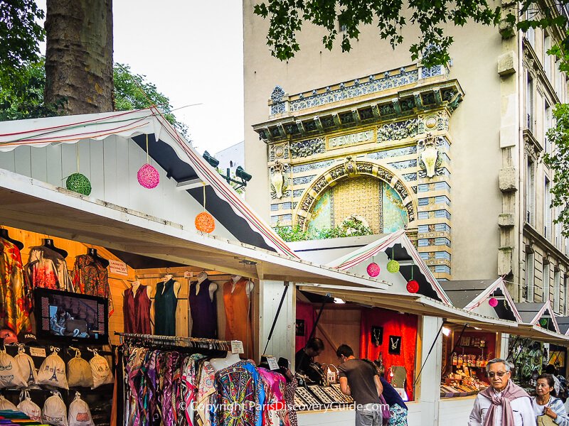 Chalets at the Saint-Germain-des Prés Christmas Market selling high-quality wool and cashmere scarves and hand-crafted jewelry