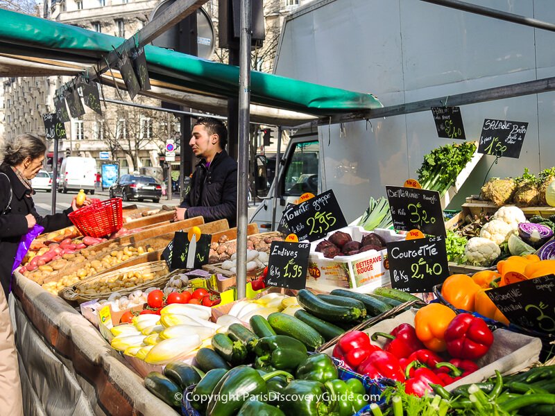 Shopping for produce at a street market in Paris