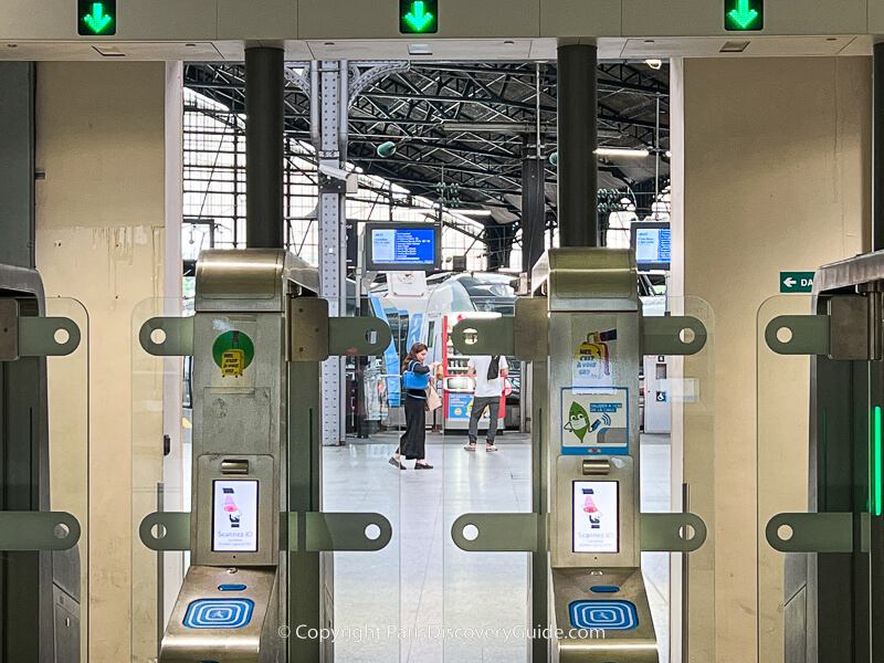 Plexiglass gates and ticket validation machines in front of the track area