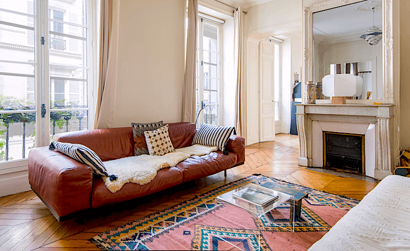 Living room and a glimpse of the bedroom at the 'Pardon My French' apartment near the National Museum des Arts et Métiers