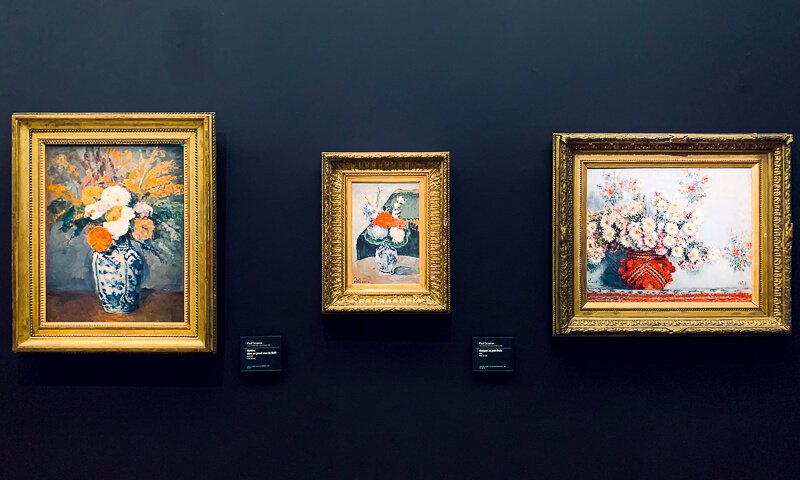 Still lifes of flowers in vases painted by Cezanne (the two on the left) and Monet (right)