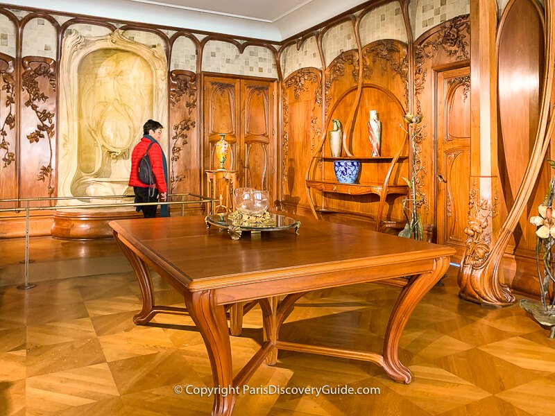 This Art Nouveau dining room paneling and furnishings made in 1900 by French sculptor and cabinet-maker Alexandre Charpentier uses only plant and flower decorative elements
