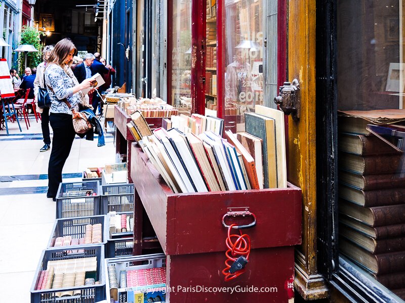 Bins of books outside used bookstore in Passage Verdeau