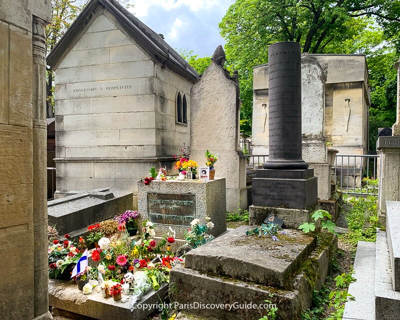 Flowers, candles, and momentos on Jim Morrison's grave in Pere Lachaise Cemetery