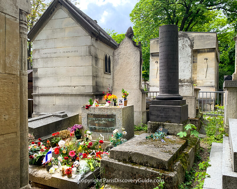 Flowers, candles, and momentos on Jim Morrison's grave in Pere Lachaise Cemetery Flowers, candles, and momentos on Jim Morrison's grave in Pere Lachaise Cemetery