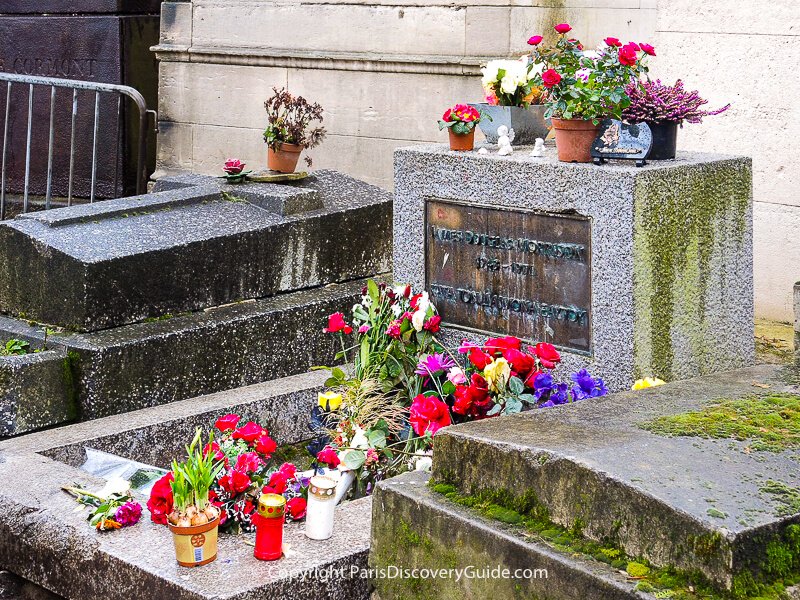Flowers, candles, and momentos on Jim Morrison's grave in Pere Lachaise Cemetery