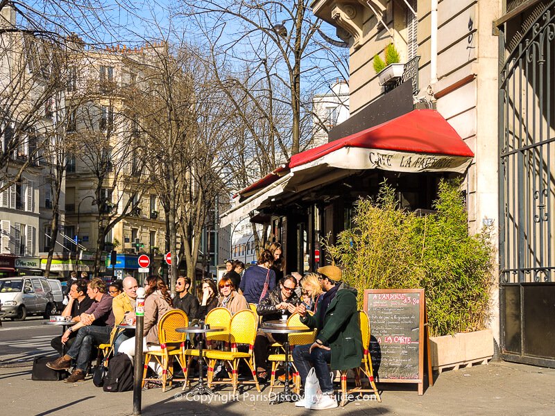 Outdoor seating at Cafe La Factorie Saint Amour next to Pere Lachaise Cemetery in early March