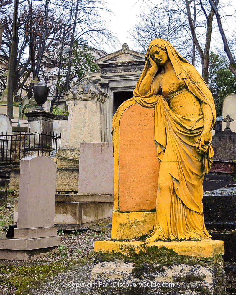 Gold-painted statue of the grieving widow of Louis-Sébastien Gourlot in Pere Lachaise Cemetery in Paris