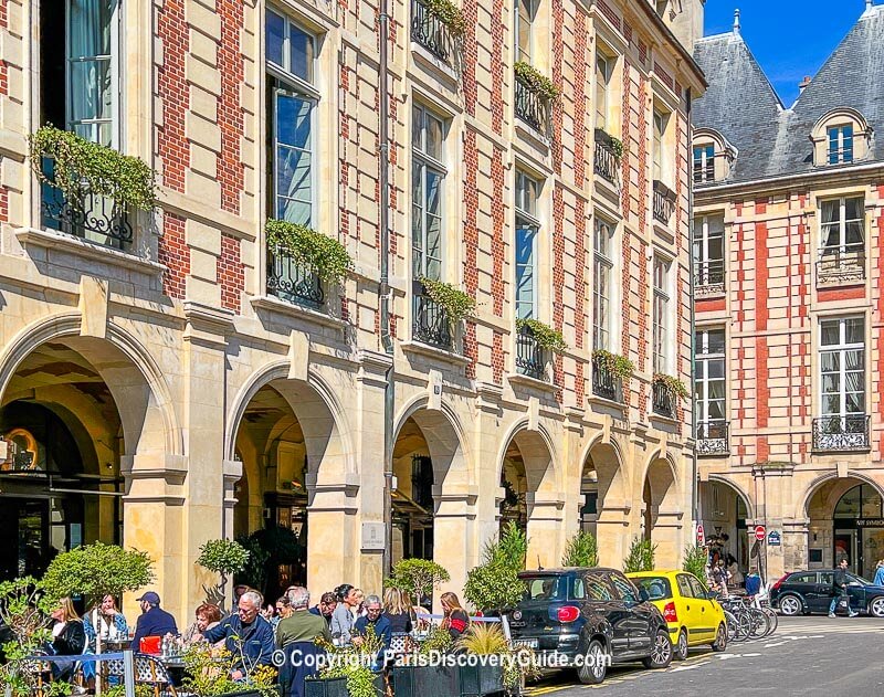 Covered arcades across from Place de Vosges in the Marais
