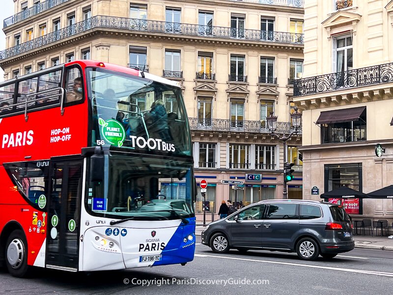 Paris tour bus with a covered upper deck on Avenue de l'Opera on a chilly overcast afternoon