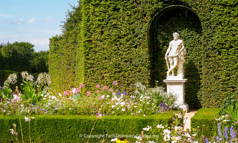 Formal garden room and statue at Versailles Gardens