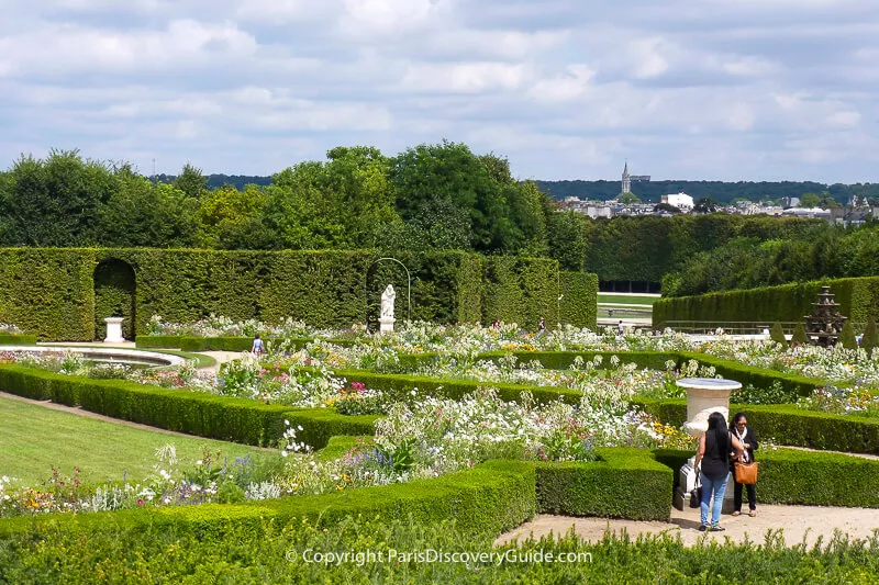 Formal garden at Versailles, with distant view of town of Versailles