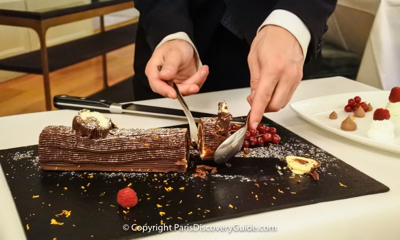 A slice of Bûche de Noël being served as dessert at "La Cuisine de l'E7" restaurant at Hotel Edouard VII near the Paris Opera House 