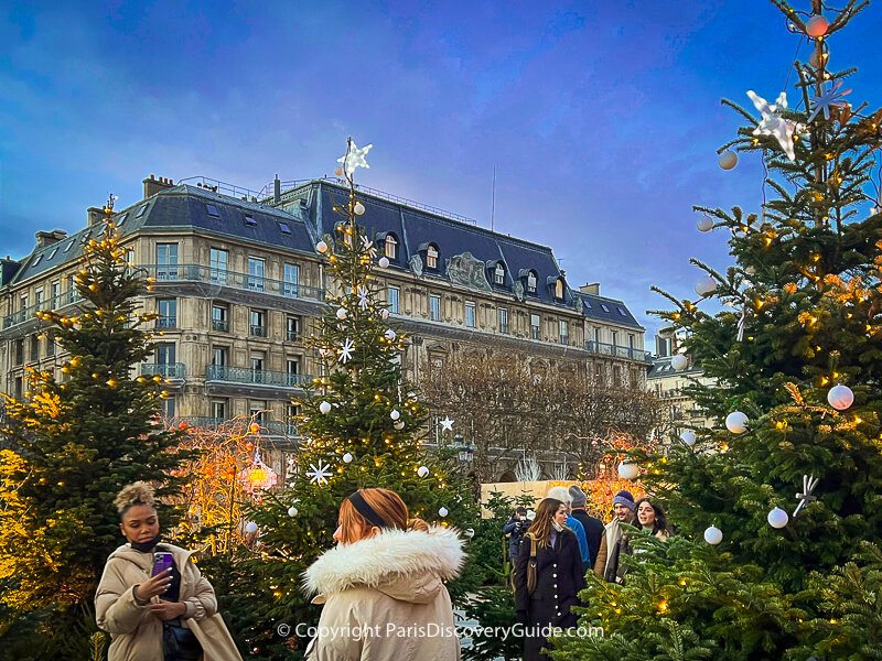 Taking selfies and walking around the decorated Christmas trees in front of Hotel de Ville