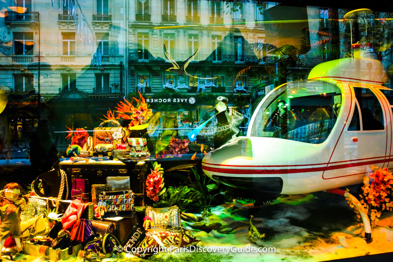 In this window, the children have landed in an airplane at the bottom of the sea amid coral reefs and a treasure chest filled with Fendi designer handbags