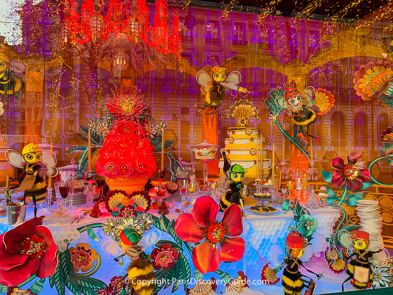 Bees prepare for the holidays in a magical world of brilliant flowers- part of a multi-window scene at Galeries Lafayette